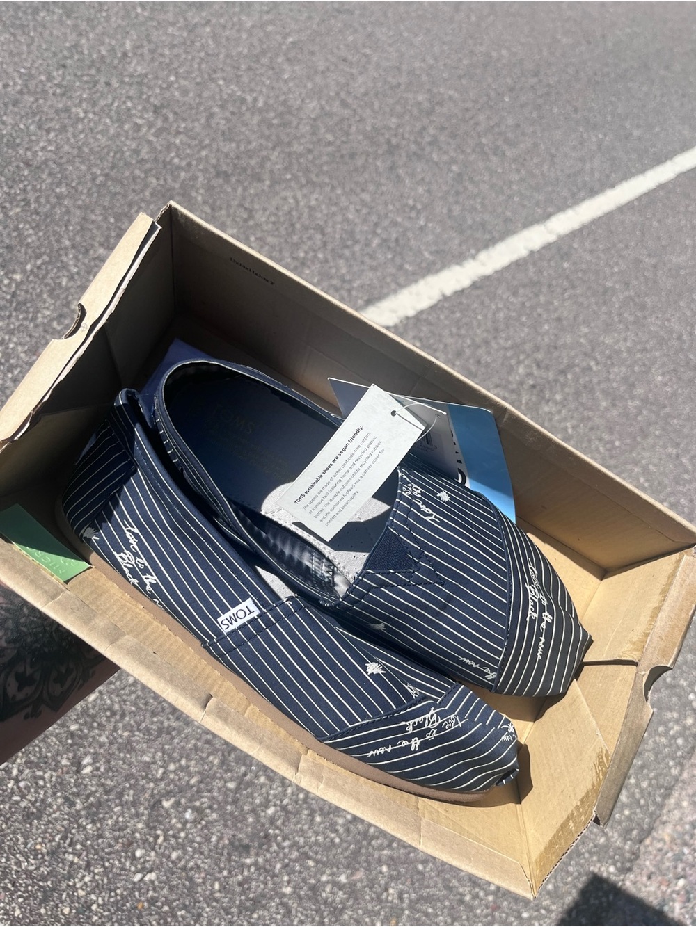 TOMS Women's “Love is the new black” Navy Pinstripe Slip-On Shoes